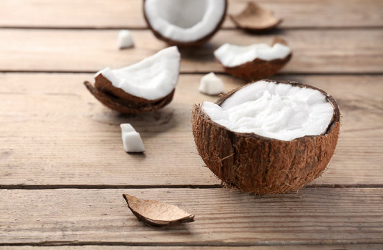 Coconut oil in shell on wooden table