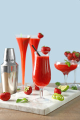 Glasses of delicious strawberry daiquiri on table
