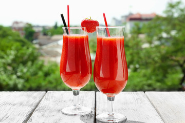 Glasses of delicious strawberry daiquiri on table