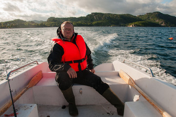 Fototapeta premium Fisherman in a motor boat