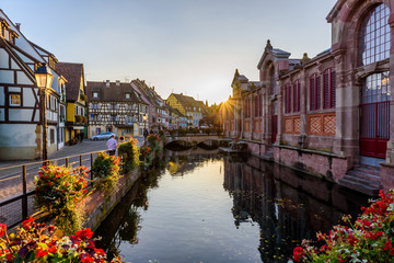 Fototapeta na wymiar Beautiful view of the historic town of Colmar, also known as Little Venice, boat ride along traditional colorful houses on idyllic river Lauch in summer, Colmar, Alsace, France