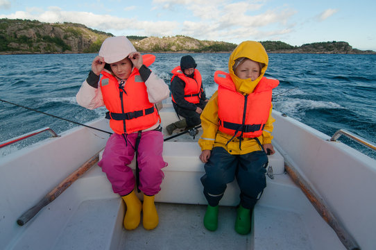 Kids In A Floating Boat Wearing The Life Vests