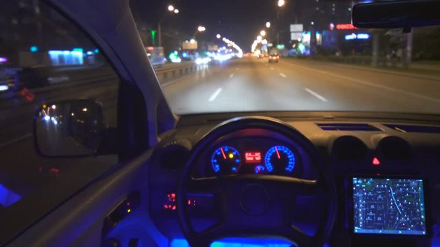 The autopilot drive a car in the city. night time, inside view