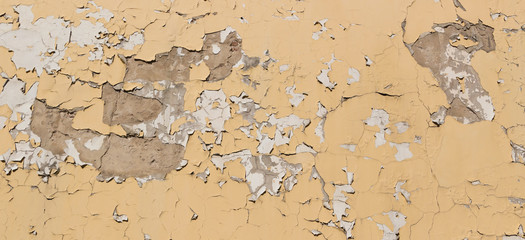 Background of old yellow cracked wall