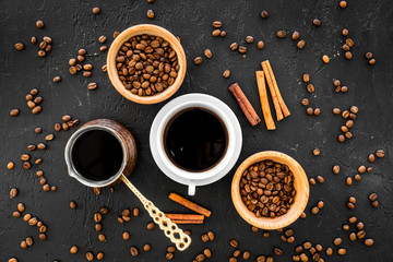 Brew coffee in turkish coffee pot. Black background top view