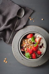 granola and yogurt with seeds and strawberry for breakfast