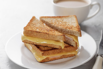 Fototapeta na wymiar Grilled cheese sandwich of wholegrain bread with coffee for healthy breakfast.