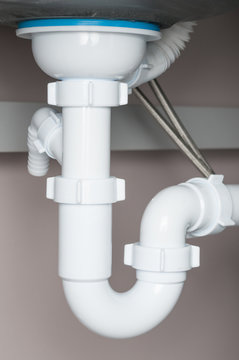 Water pipes under sink closeup