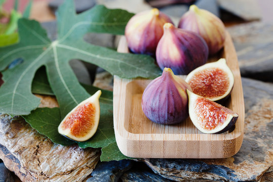 Fresh figues in wooden bowl, close up