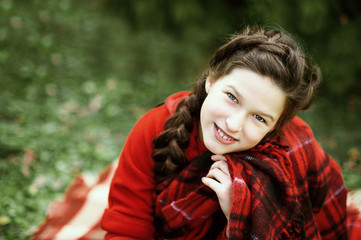 Smile girl waiting for a Christmas in the wood.