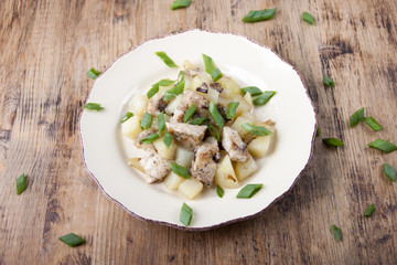 Fried potatoes with chicken and mushrooms