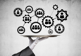 Waiter hand with white gloves holding silver plate full of social media communication icons