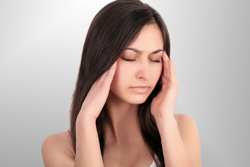Fototapeta premium Health And Pain. Stressed Exhausted Young Woman Having Strong Tension Headache. Closeup Portrait Of Beautiful Sick Girl Suffering From Head Migraine, Feeling Pressure And Stress. High Resolution Image