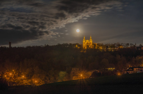 Cvilin hill in the night with church, observation tower and full moon, Krnov, Czech Republic