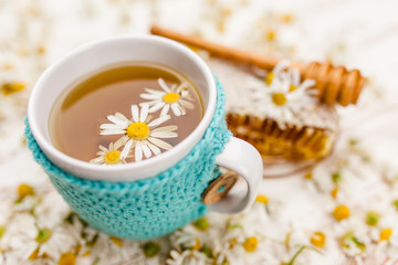 Honeycomb and chamomile tea on white