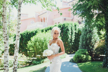 Bride with bouquet peony, the bride's bouquet, wedding day. Bride on a walk in a stylish dress