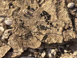 Dry cracked and rough cement with stones