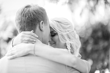 The young couple, the beginning of family life - a wedding, a portrait of the groom and bride is in love
