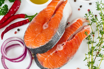 pieces of salmon and herbs over white