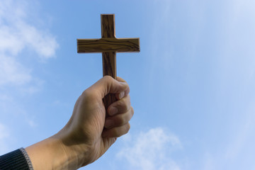 holding wooden cross