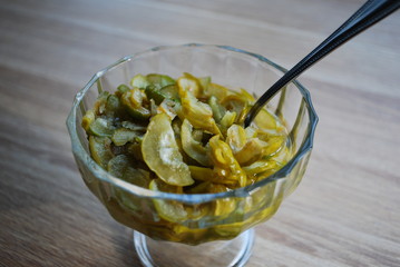 Jam from slices of Chaenomeles japonica (known as Maule's quince) green and yellow fruits in the glass bowl.