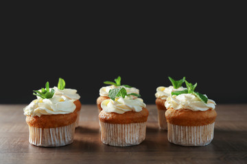 Delicious carrot cupcakes on wooden table