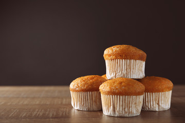 Delicious carrot muffins on wooden table