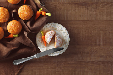 Delicious carrot muffins on wooden table