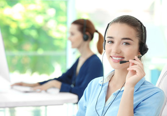 Young female technical support dispatcher working in office