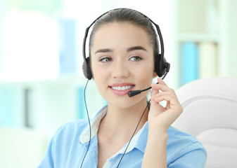 Young female technical support dispatcher working in office