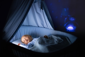 Baby boy drinking milk in bed