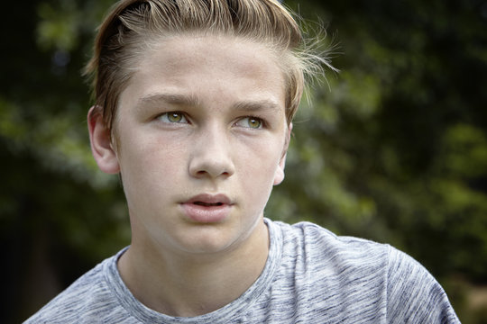 Teenage boy pauses during a run