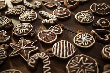 Traditional homemade Christmas ginger and chocolate cookies decorated with white sugar painting