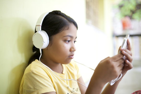Teenage girl browsing and texting in  smartphone