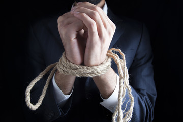 businessman's tied up hands.