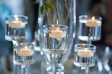 candles floating in stemware for wedding table decoration