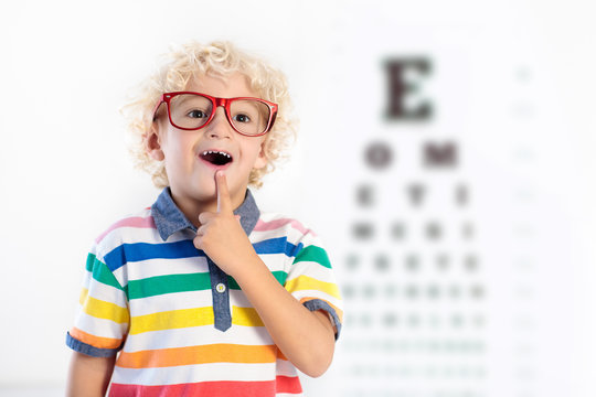 Child at eye sight test. Kid at optitian. Eyewear for kids.