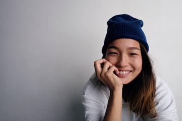 Happy Korean woman in hat smiling at camera