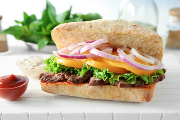 Steak sandwich on wooden table