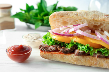 Steak sandwich on wooden table