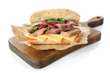 Steak sandwich and wooden board on white background
