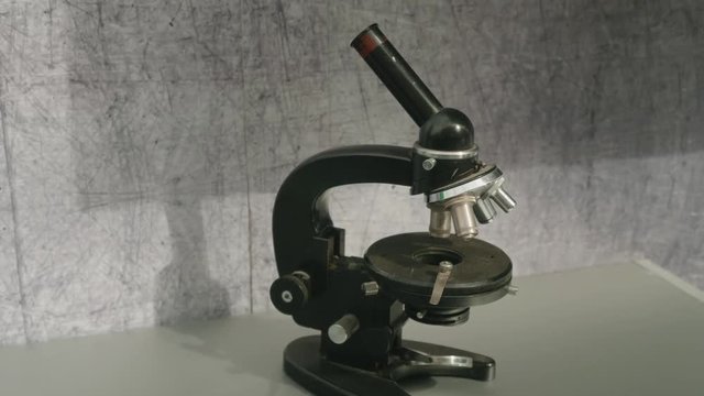 View of black microscope on concrete surface