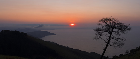 Sunset on the coast of Gipuzkoa with the orange sky in the background