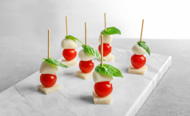 Tasty canapes for baby shower party on table