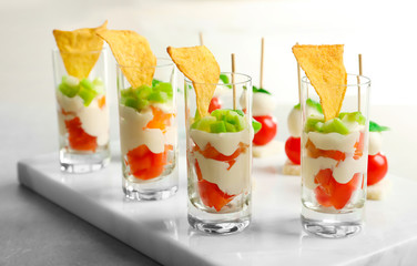 Tasty canapes and appetizers for baby shower party on marble board, closeup