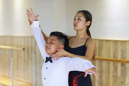 young asian dancing teacher teach her student dance indoor