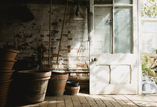 Pots and tools stored in a potting shed.