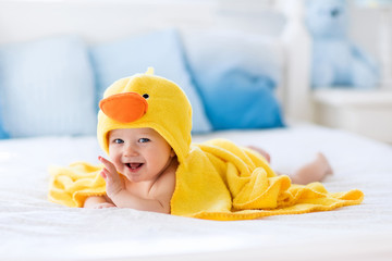 Cute baby after bath in yellow duck towel