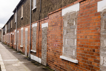Bricked up and abandoned town houses in a run-down city street