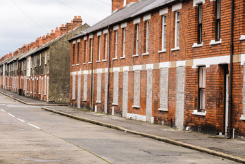 Fototapeta premium Bricked up and abandoned town houses in a run-down inner city street in Belfast